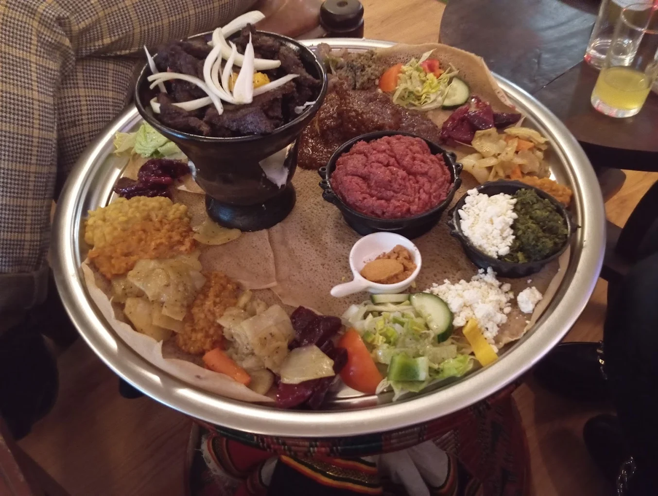 Authentic Ethiopian combination platter with injera and various traditional stews