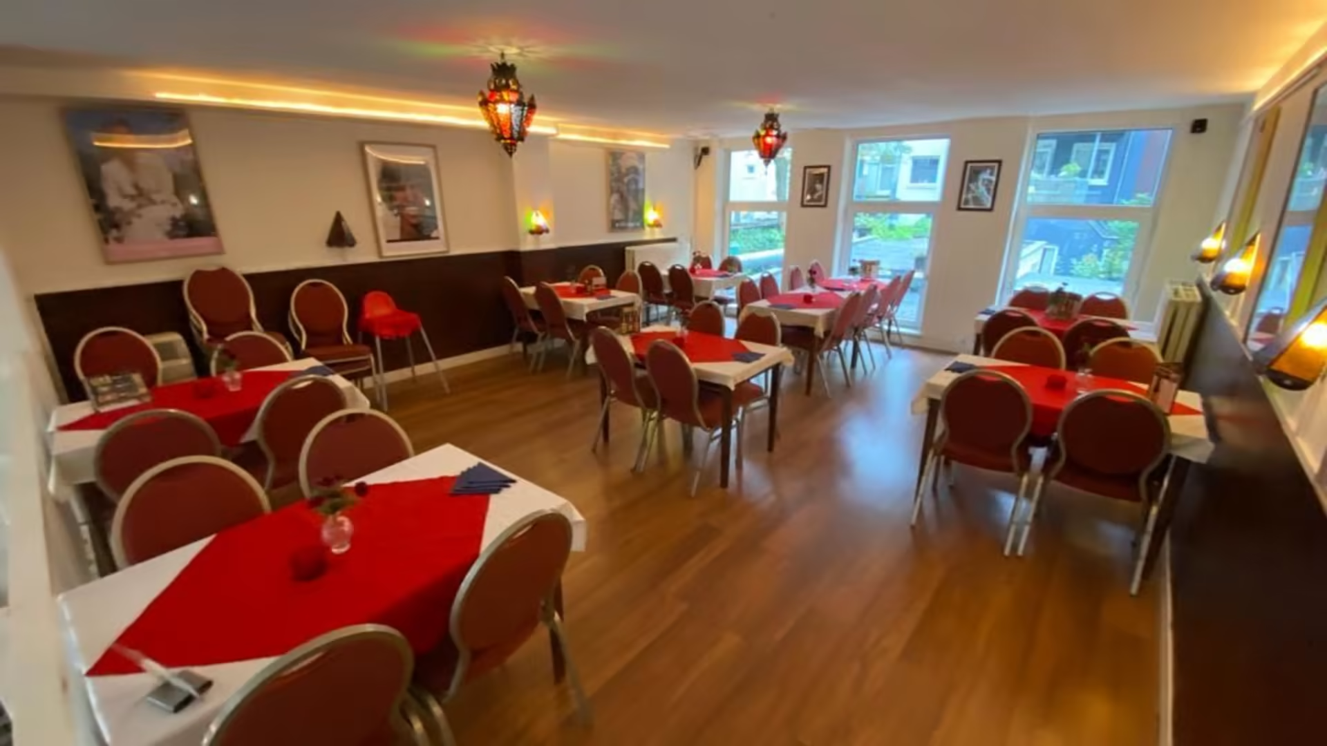 Main dining room with traditional red and white table settings and warm Ethiopian ambiance