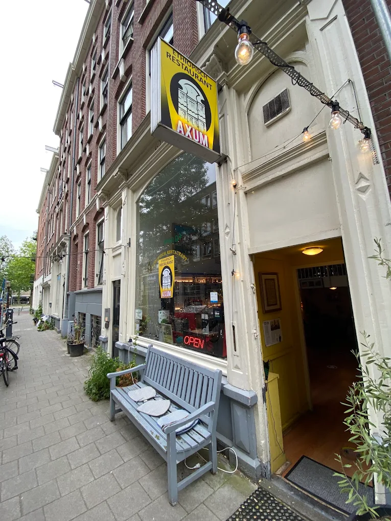 Axum restaurant entrance with outdoor seating and charming street presence