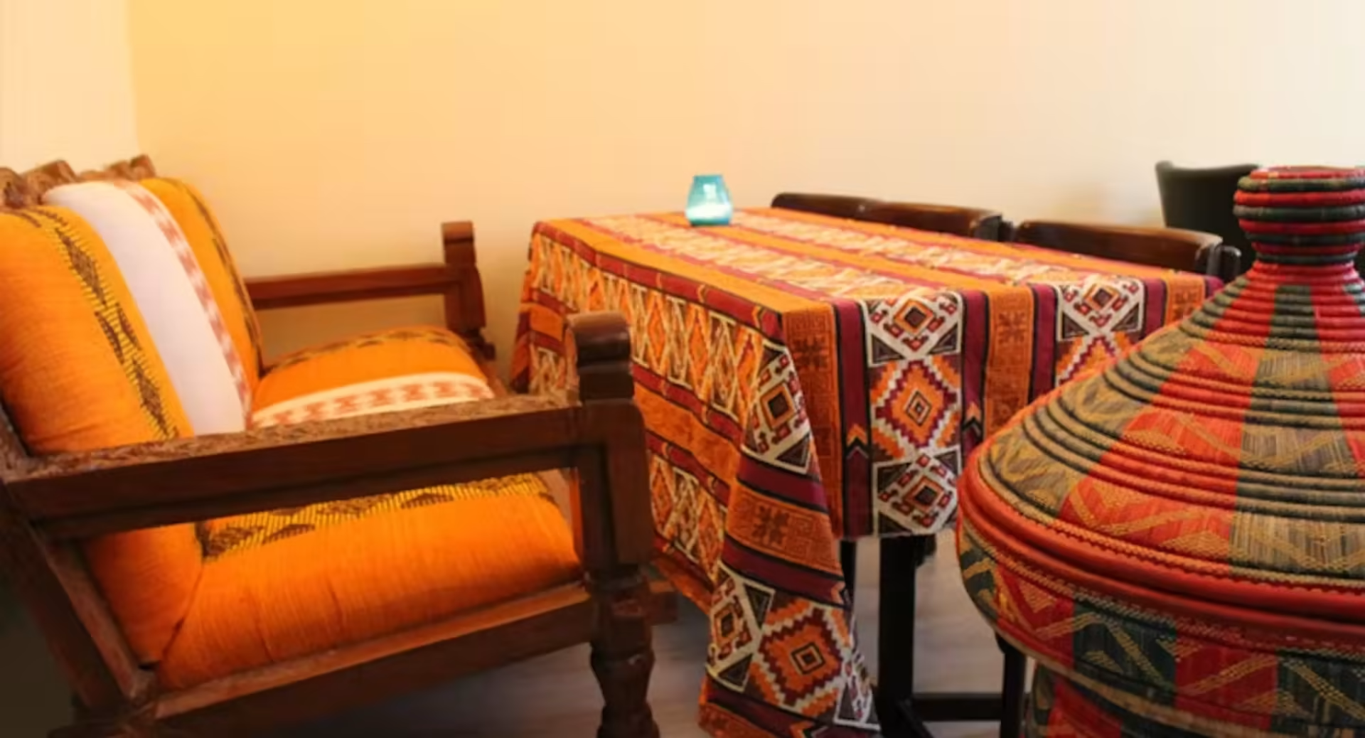 Traditional Ethiopian seating area with colorful textiles and woven baskets