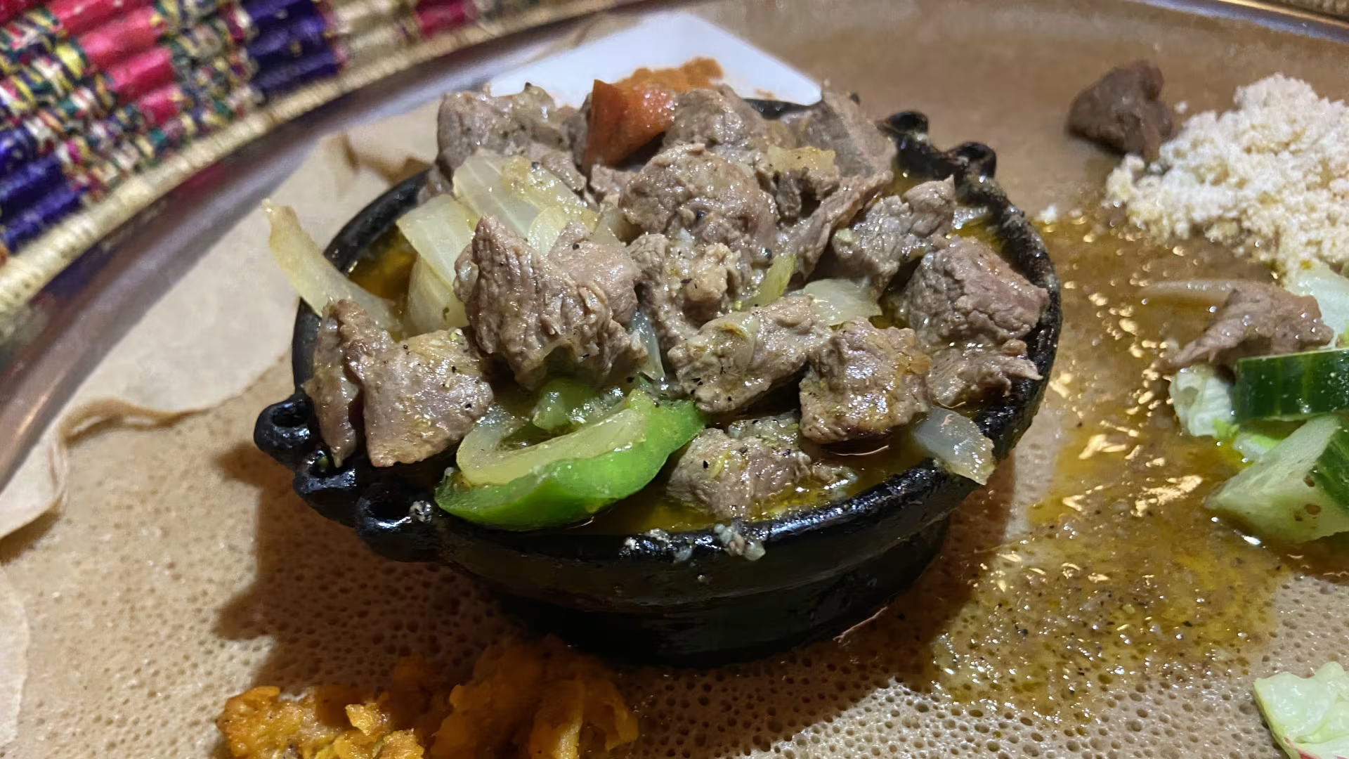 Sizzling tibs served in traditional Ethiopian clay dish
